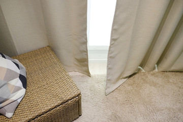Obraz na płótnie Canvas Beige curtains. Wicker furniture with pillow. Living room interior.