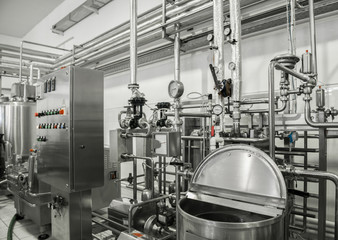 electronic control panel and tank at a milk factory. equipment at the dairy plant