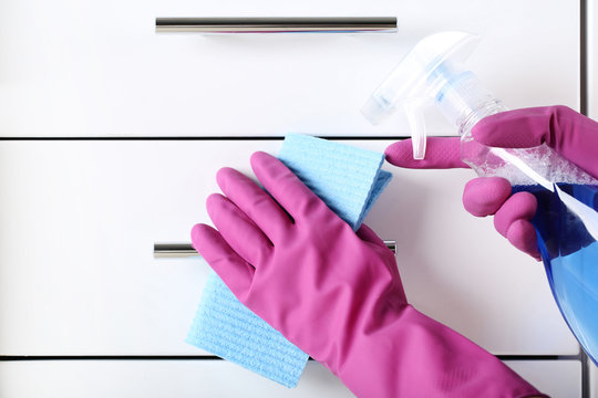 Hands In Gloves With Sponge And Bottle Of Detergent Cleaning Kitchen Drawer