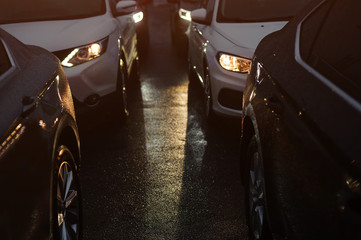 Traffic jam in the rainy night. Row of cars