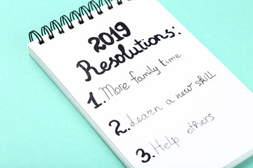 Inscription 2019 resolutions in notepad on mint background
