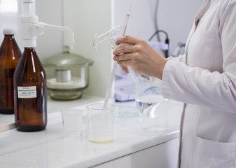 Fototapeta premium woman testing samples of dairy products in the laboratory. test laboratory of a milk factory