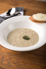 Oatmeal porridge with bread toast with cream cheese on wooden background