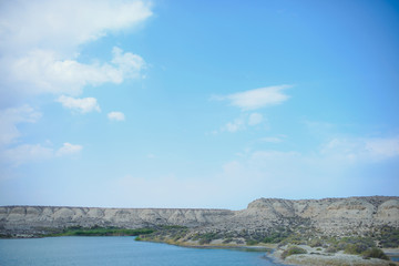 The shore of the lake in Kyrgyzstan. Preserved area. Water surface. Lake Issyk Kul. Pure sea water....