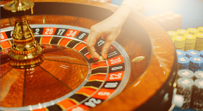 Female hand roulette in casino selective focus