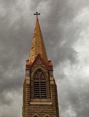 Church tower with gray cloudy sky