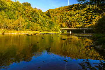 Fototapeta na wymiar Bieszczady Mountains, Rajskie Poland, San river, view on streem in sunny autumn day. 