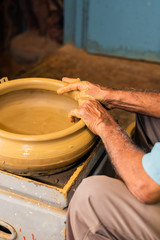 Local artisan working on clay pottery in Goa,India