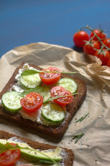 sandwiches with ricotta, avocado, cherry tomatoes and cucumbers