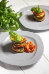 ratatouille healthy veggie traditional recipe on white wooden background with basil leaves
