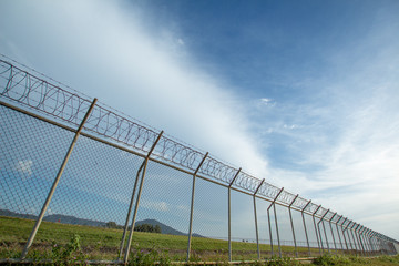 Metal fence wire, War and sky in the background in Phuket Thailand