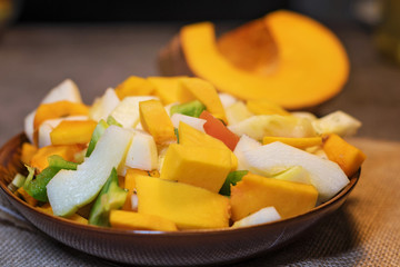 Fresh vegetables (squash, pumpkin, tomatoes, pepper..) cut for cooking. Vegetarian dish.