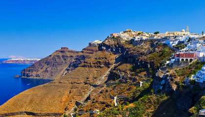 Landscape of famous Santorini with white houses on hill