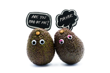 Romantic avocados couple with googly eyes and speech bubbles with text, funny food and love concept for creative projects