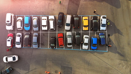 Aerial. Little city parking lot with colorful cars. Transportation background. © Dmytro
