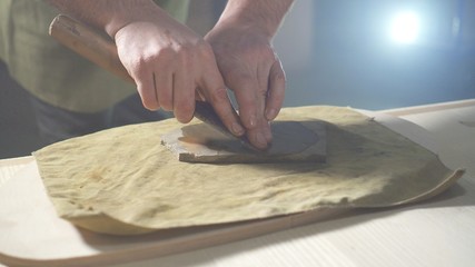 Sharpening carpenter's hand tool for working on wood close up, men's hands