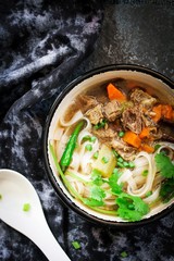 Pho Vietnamse Noodle Soup in a bowl overhead view with copy space
