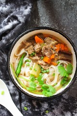 Pho Vietnamse Noodle Soup in a bowl overhead view with copy space