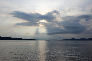 Seascape sunset with dramatic clouds and reflection on the water