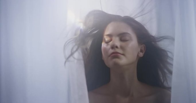 portrait beautiful young caucasian woman wind blowing hair looking seductive female beauty in sensual fantasy dream between sheets