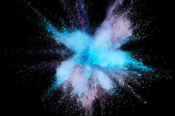 Colored powder explosion. Abstract closeup dust on backdrop. Colorful explode. Paint holi