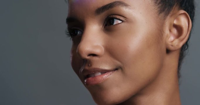 close up multicolor portrait beautiful african american woman with colorful light reflecting on face perfect skin looking healthy complexion skincare concept