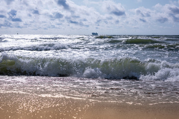 Empty beach, waves and dramatic sky at the Baltic sea shore line, Lithuania, Klaipeda