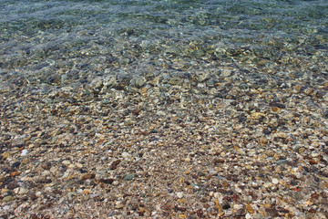Water sea ocean sand pebbles beach swash wave waterline shallow surface texture clear summer nobody...