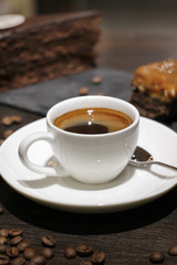 Cup of coffe with cake and beans