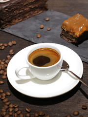 Cup of coffe with cake and beans