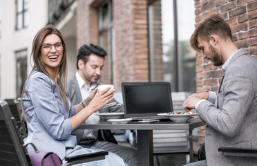 employees sitting at a table in a cafe