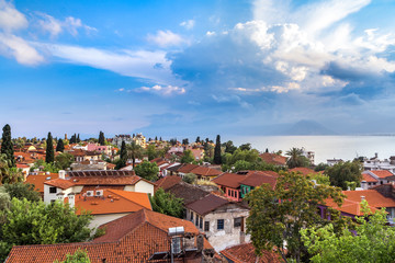 Fototapeta na wymiar Landscape from the window to the roofs and the sea in the area of Kaleici, Antalya, Turkey