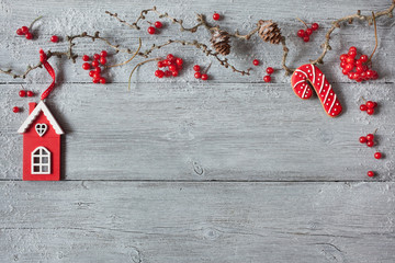 Christmas background of wood, branches, cones, red berries and home decor