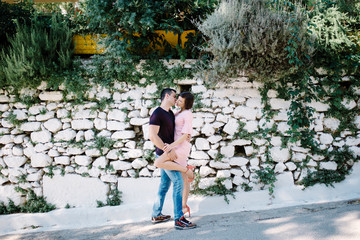 Young couple hugging and flirting in park meeting after a separation.