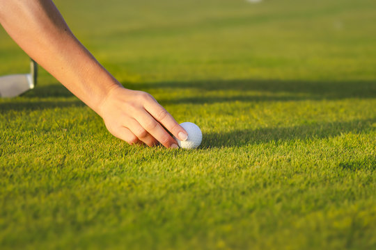 Hand Placing Golf Ball On Tee