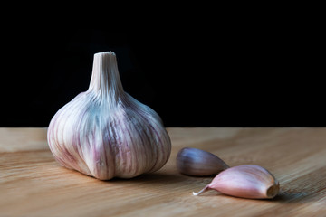 Organic garlic on wooden background.
