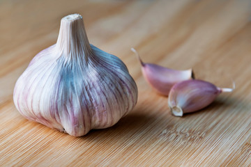 Organic garlic on wooden background.