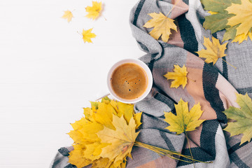 Top view mug of coffee among flat layout of autumn leaves