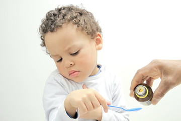Young boy taking medicine stock photo