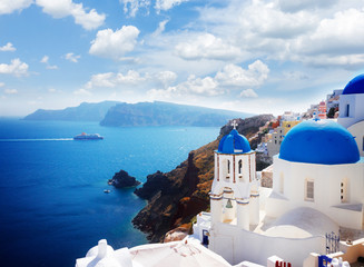 volcano caldera with blue church domes, Oia and sky with clouds, Santorini