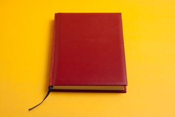 concept business time is money, a new beautiful red notebook and pen for responsible people on a bright yellow background