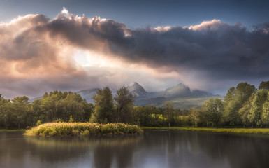 Strba Lake under the  Peaks of High Tatras Mountains Lit by Golden Light at Sunset
