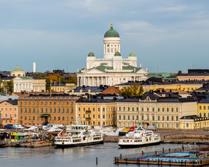 Helsinki, Finland. Scenic cityscape with Helsinki Cathedral, South Harbor, Market Square (Kauppatori) and beautiful cirrus clouds over them in the sunny spring day.