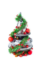 Abstract christmas tree of car parts on a white background. Decorated with Christmas toys, garland