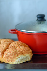 Hot plate for the Sabbath. Pot with traditional food and challah-special bread in Jewish cuisine. Traditional food Jewish Shabbat.