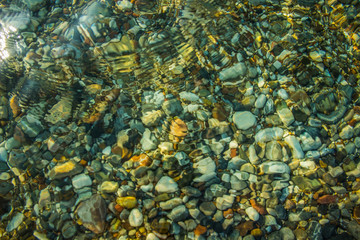Fototapeta na wymiar abstract transparent sea water background with view on colorful fuzzy stones bottom, copy space