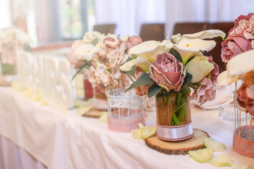 Roses on a festive wedding table in the restaurant. Wedding decoration