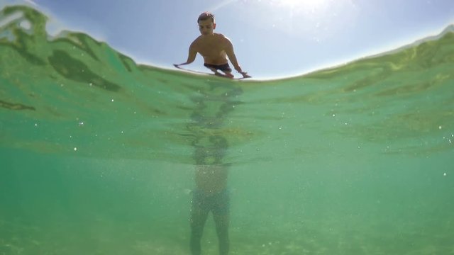 Teen makes backflip jump from his father shoulder in sea on summer vacation, gopro dome shot