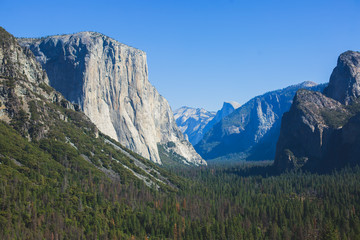 Beautiful summer view of Yosemite Valley , with El Capitan mountain, Half Dome mountain, Bridalveil waterfall, seen from Tunnel View vista point, Yosemite National Park, California, USA