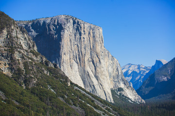 Fototapeta na wymiar Beautiful summer view of Yosemite Valley , with El Capitan mountain, Half Dome mountain, Bridalveil waterfall, seen from Tunnel View vista point, Yosemite National Park, California, USA